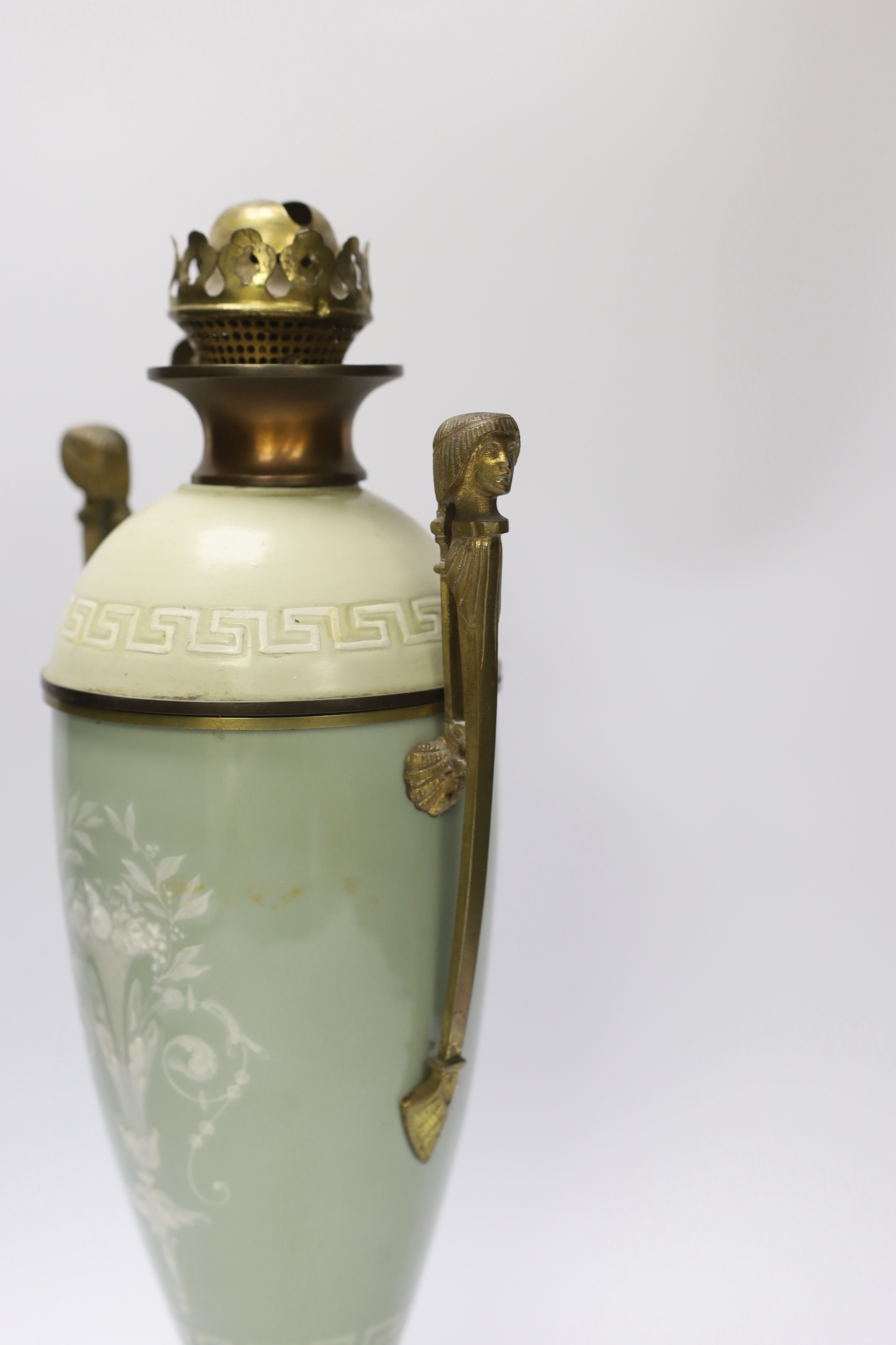 A late 19th century pate sur pate and gilt metal oil lamp with twin handles (restoration), 44cm